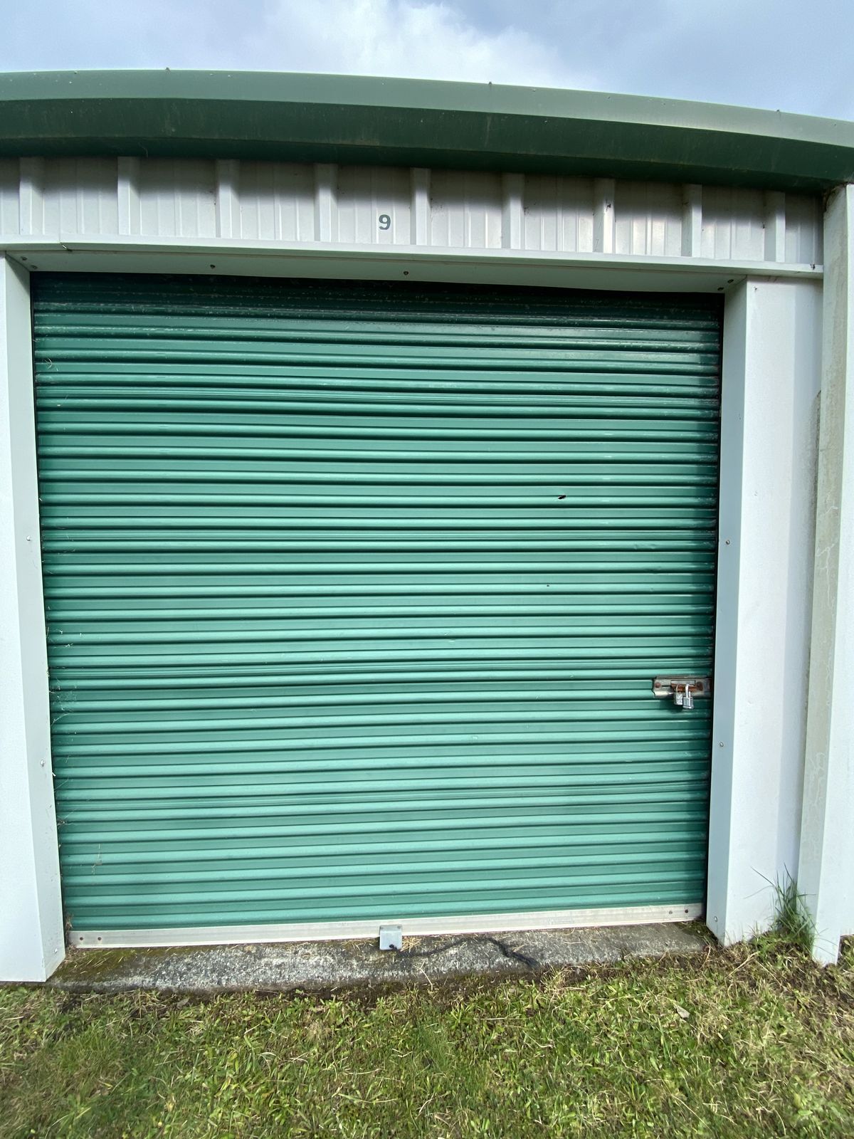 Green roll-up door on a storage unit